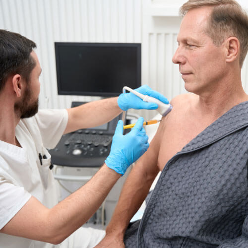 Homem de meia idade passando por procedimento de amostragem por biópsia na Global exames